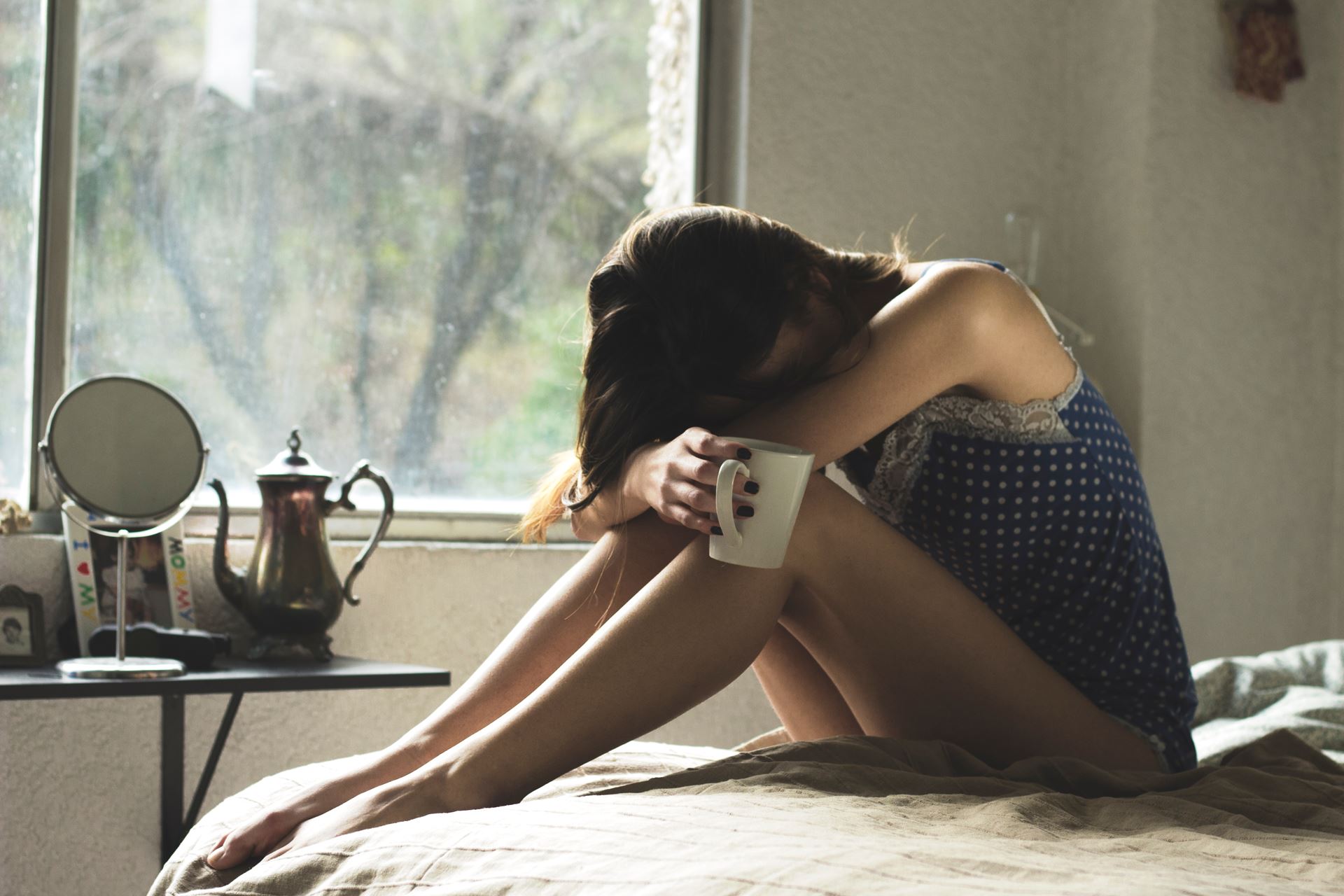 a woman sitting on a bed