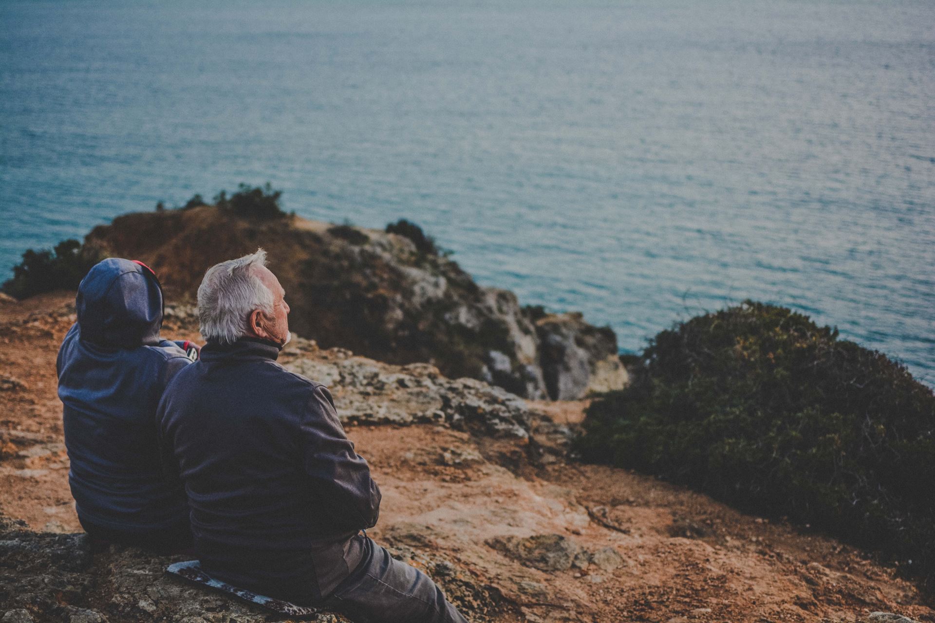 a man standing next to a body of water